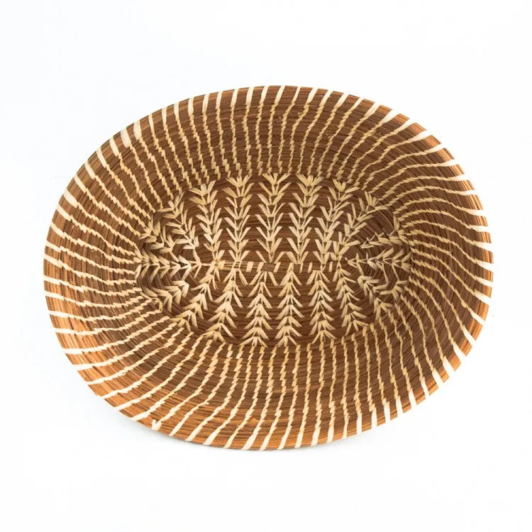 Oval pine needle basket with raffia